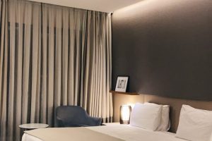 white bed with gray pillow